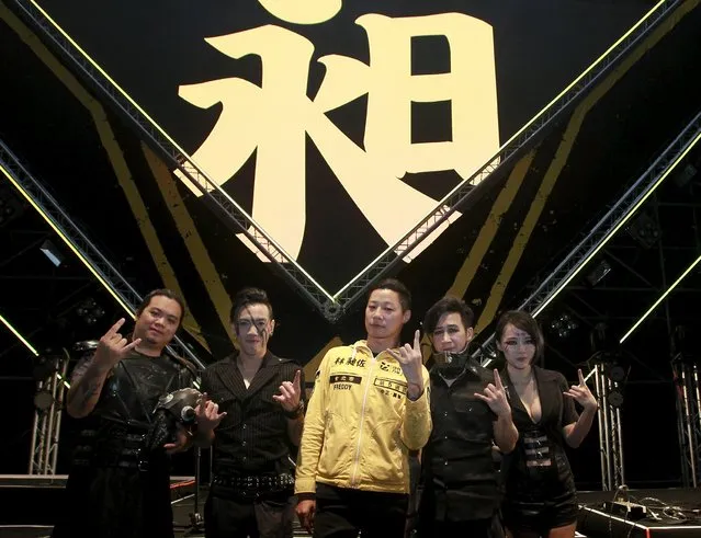 Freddy Lim (C), a candidate to the 2016 legislative election and singer of death metal band Chthonic, and members of Chthonic pose for photographers during an interview with reporters after a concert to boost his campaign in Taipei, Taiwan, December 26, 2015. (Photo by Pichi Chuang/Reuters)