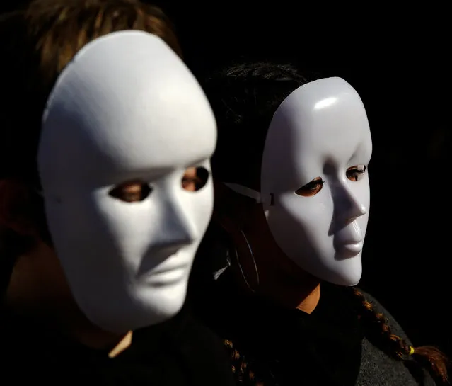 Gender studies students wear masks during a performance to commemorate victims of gender violence, during the U.N. International Day for the Elimination of Violence against Women in Oviedo, Spain November 25, 2016. (Photo by Eloy Alonso/Reuters)