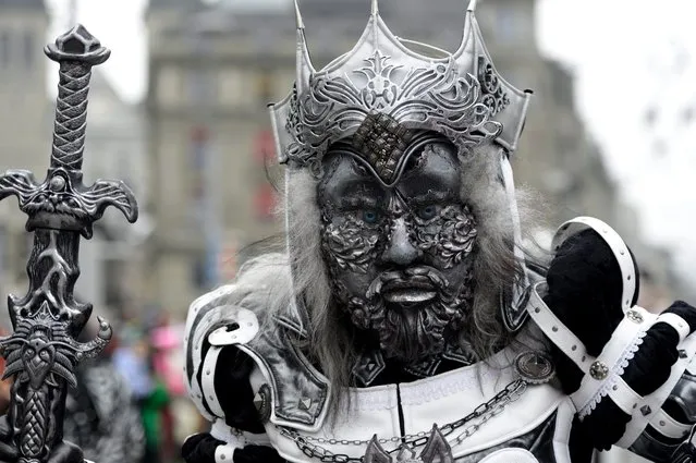 A masked reveler parades through the streets during the carnival in Lucerne, Switzerland, 16 February 2015. (Photo by Urs Flueeler/EPA)