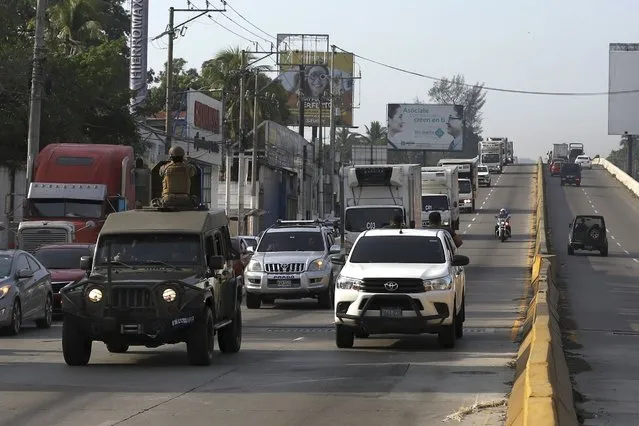 Soldiers drive ahead of Health Ministry trucks transporting COVID-19 vaccines that El Salvador's government is donating to Honduras as they depart San Salvador, El Salvador, Thursday, May 13, 2021. (Photo by Salvador Melendez/AP Photo)