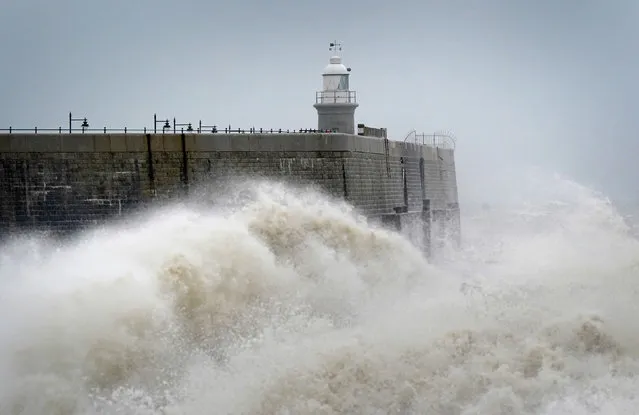 Waves crash against the harbour wall during strong winds in Folkestone, Kent on Friday, March 31, 2023. (Photo by Gareth Fuller/PA Wire Press Association)