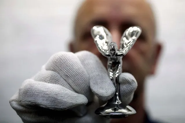 Worker Ronald Little displays a finished “Spirit of Ecstasy”. (Photo by Stefan Wermuth/Reuters)