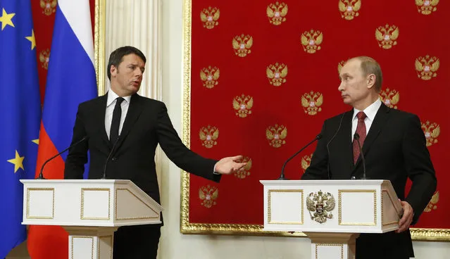 Italian Prime Minister Matteo Renzi , left, speaks as Russian President Vladimir Putin, listens, during their news conference after their talks in the Kremlin in Moscow, Russia, Thursday, March 5, 2015. Italy's prime minister visited Moscow on Thursday in a bid to repair ties that have been hurt by Russia-West tensions over Ukraine. (AP Photo/Sergei Karpukhin, Pool)