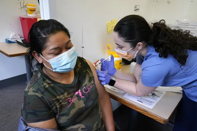 Medical assistant Andreea Marian, right, gives a COVID-19 vaccine to Gabina Morales at a clinic at PeaceHealth St. Joseph Medical Center Thursday, June 3, 2021, in Bellingham, Wash. Washington is the latest state to offer prizes to encourage people to get vaccinated against COVID-19, with Gov. Jay Inslee on Thursday announcing a series of giveaways during the month of June that includes lottery drawings totaling $2 million, college tuition assistance, airline tickets and game systems. (Photo by Elaine Thompson/AP Photo)