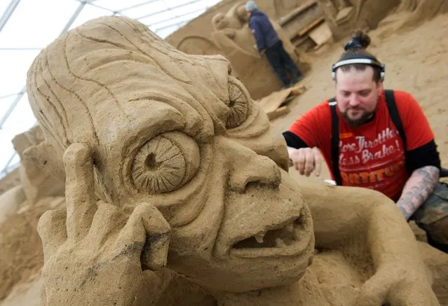 Finnish sand sculptor Pasi Ahokas carves the "Gollum" character from the movie “Lord of the Rings” as preparations are under way for a sand sculpture festival in Binz on the Baltic island of Ruegen, northeastern Germany, on March 17, 2015. Carvers from all over the World create sculptures from 16,000 tons of special sand for the festival themed “TV and Movie”. The festival starts on March 21, 2015. (Photo by Stefan Sauer/AFP Photo/DPA)