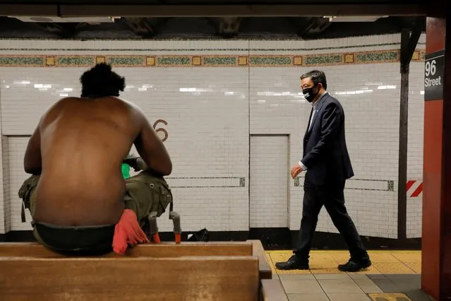 Democratic New York City Mayoral candidate Andrew Yang walks past a person in a subway station during the New York City primary mayoral election, in Manhattan, June 22, 2021. (Photo by Andrew Kelly/Reuters)