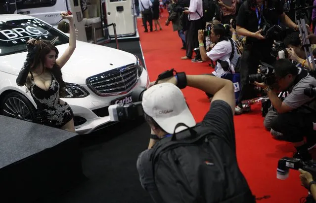 Photographers take picture of automotive models during the 36th Bangkok International Motor Show in Bangkok, Thailand, March 24, 2015. (Photo by Jurnasyanto Sukarno/JG Photo)