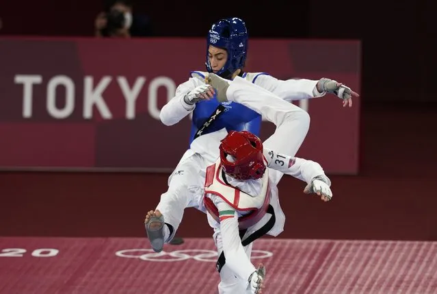 Iran's Nahid Kiyani, front, attacks Kimia Alizadeh, of the Refugee Olympic Team, during the women's 57kg match at the 2020 Summer Olympics, Sunday, July 25, 2021, in Tokyo, Japan. (Photo by Themba Hadebe/AP Photo)