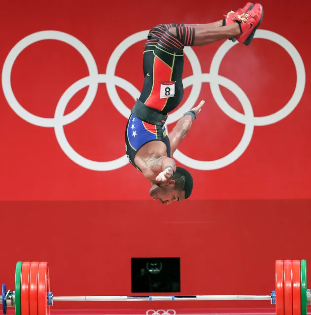Julio Ruben Mayora Pernia of Venezuela somersaults during the men's 73kg weightlifting event of the Tokyo 2020 Olympic Games in Tokyo, Japan, July 28, 2021. (Photo by Xinhua News Agency/Rex Features/Shutterstock)