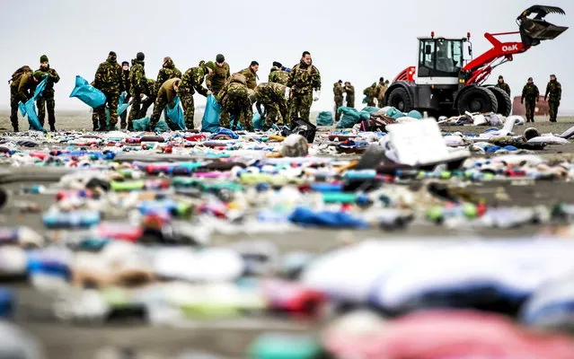 Dutch soldiers clean up the coastline after goods from shipping containers of the container vessel “MSC Zoe” washed up on the shores of Schiermonnikoog island, the Netherlands, 04 January 2019. The vessel has lost about 270 containers in rough sea along the coastline of the Netherlands on its way from Portugal to Bremerhaven. (Photo by Remko De Waal/EPA/EFE)