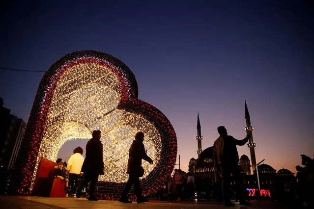 A person takes a selfie with a New Year's Eve decoration at Taksim Square in central Istanbul, Turkey on December 28, 2023. (Photo by ilara Senkaya/Reuters)