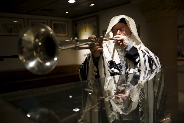 U.S.-Israeli musicologist David Louis plays a trumpet as part of a demonstration of biblical instruments at the Temple Institute in Jerusalem January 25, 2016. (Photo by Ronen Zvulun/Reuters)