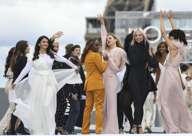 Aishwarya Rai Bachchan, from left, Helen Mirren and Amber Heard, fourth from left, wear creations for the L'Oreal Spring-Summer 2022 ready-to-wear fashion show presented in Paris, Sunday, October 3, 2021. (Photo by Vianney Le Caer/Invision/AP Photo)
