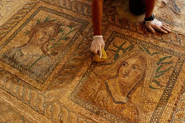 A photo shows restored mosaics, that shed light to 1800 years ago, at Metropolis Ancient City in Torbali district of Turkey's Izmir on October 12, 2021. After using modern techniques that ensure the preservation of colors and grains for a longer time, mosaics resembling the paintings of Eros, the God of love in Greek mythology, ancient Greek god Dionysus and his wife Ariadne, became prominent. (Photo by Mehmet Emin Menguarslan/Anadolu Agency via Getty Images)