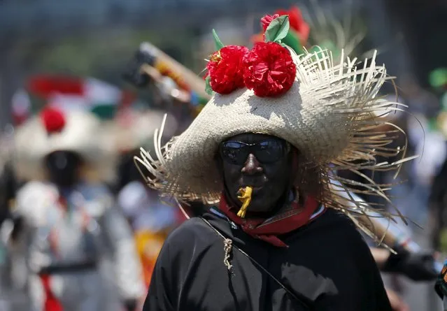 A Mexican in period costume takes part during re-enacts the battle of Puebla, along a street in Mexico City May 5, 2015. (Photo by Henry Romero/Reuters)