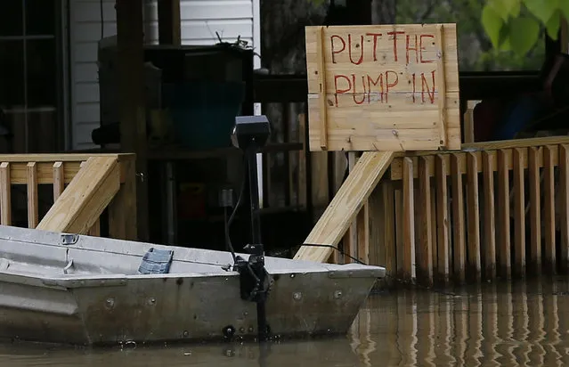A Issaquena County, Miss., resident, posts the sentiment calling for a flood control and drainage project as backwater surrounds the house, Friday, April 5, 2019. Residents and farmers are calling for a flood control and drainage project as part of a long-term plan to help the people in the rural flatlands where backwater flood waters have been standing for weeks. (Photo by Rogelio V. Solis/AP Photo)