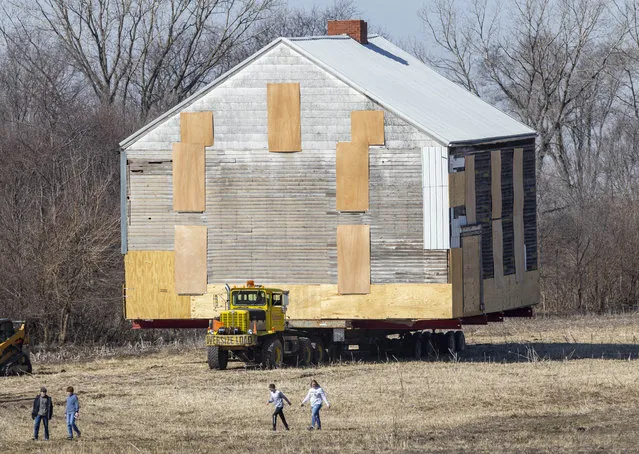 The Stage Coach Inn building is transported along corn fields to avoid power lines in West Liberty, Iowa on Sunday, February 25, 2024. The building was moved about three miles by the West Liberty Heritage Foundation to Heritage Park. (Photo by Savannah Blake/The Gazette via AP Photo)
