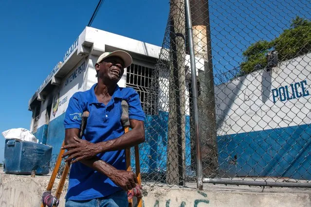 A man cries outside the Carrefour Aeroport police station, which was set on fire on 04 March by gang members, in Port-au-Prince, Haiti, 05 March 2024. The streets of Port-au-Prince show apparent normality after the intense shootings the day before, although in some places bodies continue to appear. The population tries to recover normality and dedicates themselves to their daily tasks, despite the fact that on their way, as EFE was able to verify, they come across corpses that some people cover with a blanket, while others are simple charred remains. (Photo by Johnson Sabin/EPA)