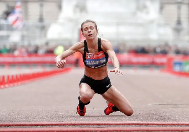 Great Britain's Hayley Carruthers collapses before the finish line in the women's race at the 39th London Marathon in London, Sunday, April 28, 2019. (Photo by Alastair Grant/AP Photo)