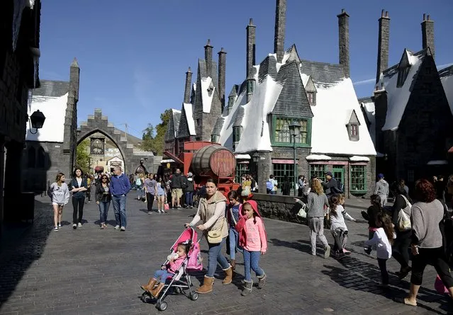 Guests walk through Hogsmeade Village during a soft opening and media tour of “The Wizarding World of Harry Potter” theme park at the Universal Studios Hollywood in Los Angeles, California in this picture taken March 22, 2016. (Photo by Kevork Djansezian/Reuters)