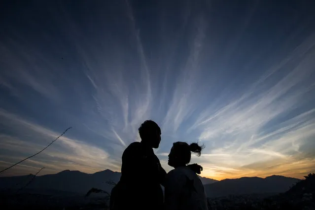 A Nepalese couple is silhouetted against the setting sun in Kathmandu, Nepal, February 17, 2016. (Photo by Narendra Shrestha/EPA)