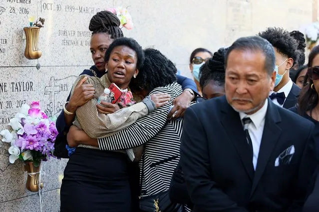 Lauren Meek, the granddaughter of U.S. Rep. Carrie Meek (D-FL), is comforted during the internment service at the Caballero Rivero Dade North Memorial Park on December 07, 2021 in Miami, Florida. (Photo by Joe Raedle/Getty Images)