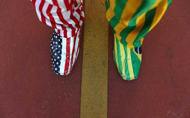 A man uses shoes with U.S and Brazil's colors as he takes part in a pro-government demonstration at Paulista avenue in Sao Paulo, Brazil on May 26, 2019. (Photo by Nacho Doce/Reuters)