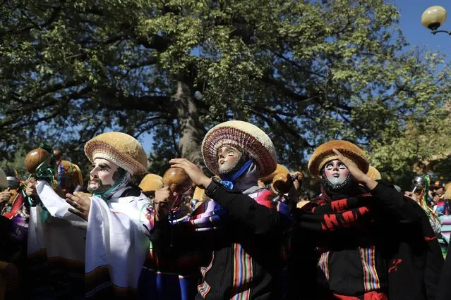 Hundreds of men wear costumes as Parachico; traditional dancers of the Fiesta Grande de Chiapas that takes place from January 8 to 23 in this heroic magical town in Chiapa de Corzo, Mexico on January 15, 2022. In this day they went out to tour the main streets of the city and danced in honor of San Sebastian. (Photo by Jacob Garcia/Anadolu Agency via Getty Images)