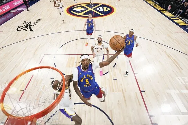 Denver Nuggets guard Kentavious Caldwell-Pope (5) goes up to shoot against Los Angeles Lakers forward LeBron James, left, during the first half in Game 1 of an NBA basketball first-round playoff series, Saturday, April 20, 2024, in Denver. (Photo by Jack Dempsey/AP Photo)