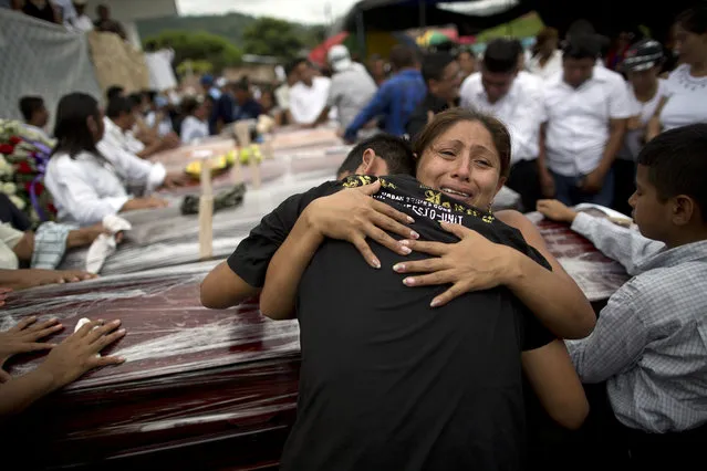 Relatives mourn the loss of their family members, victims of the 7.8-magnitude earthquake, during a funeral service in Portoviejo, Ecuador, Monday, April 18, 2016. The Saturday night quake left a trail of ruin along Ecuador’s normally placid Pacific Ocean coast. At least 350 people died and thousands are homeless. President Rafael Correa said early Monday that the death toll would “surely rise, and in a considerable way”. (Photo by Rodrigo Abd/AP Photo)