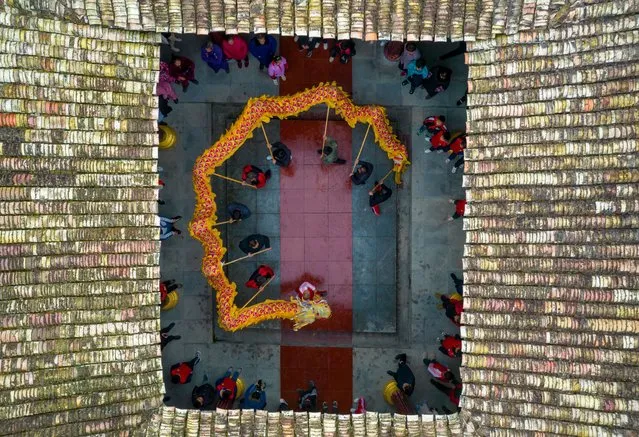 Aerial view of people practicing dragon dance ahead of Chinese New Year, the year of the Tiger, on January 14, 2022 in Xinyu, Jiangxi Province of China. (Photo by Zhao Chunliang /VCG via Getty Images)
