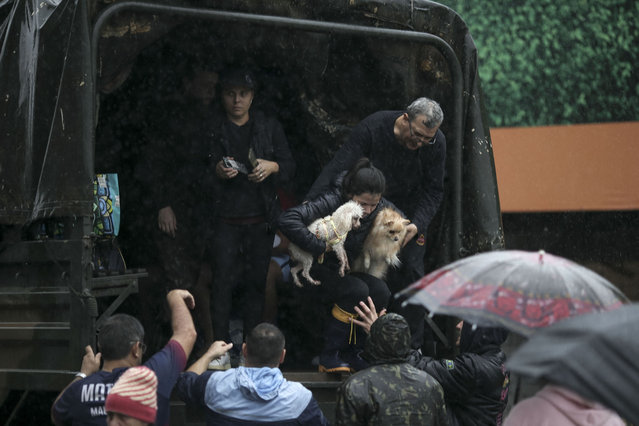 Residents remain inside an army truck after being rescued at the city center of Sao Sebastiao do Cai, Rio Grande do Sul state, Brazil on May 2, 2024. Brazilian President Luiz Inacio Lula da Silva on Thursday visited the country's south where floods and mudslides caused by torrential rains have killed 29 people, with the toll expected to rise. (Photo by Anselmo Cunha/AFP Photo)