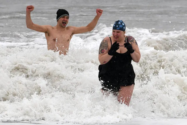 Despite the high winds and fright temperatures, about 1/2 dozen brave members of the Coney Island Polar Bear Club took a dip in the Atlantic Ocean at March 14, 2017, just of Stillwell avenue in Coney Island beach in Brooklyn NYC. Snow began blanketing northeastern United States on Tuesday as a winter storm packing blizzard conditions rolled into the region, prompting public officials to ask people to stay home while airlines grounded flights and schools canceled classes. The National Weather Service issued blizzard warnings for parts of eight states including New York, Pennsylvania, New Jersey and Connecticut, with forecasts calling for up to 2 feet of snow by early Wednesday, with temperatures 15 to 30 degrees below normal for this time of year. (Photo by Paul Martinka)