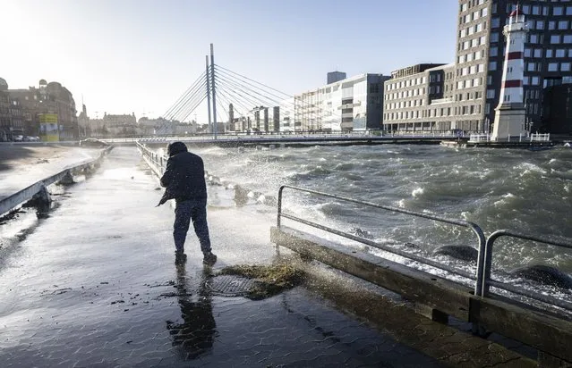 High water levels and waves hit the road in Malmo harbour, Sweden, Sunday January 30, 2022, after a powerful winter storm swept through northern Europe over the weekend. Storm Malik was advancing in the Nordic region on Sunday, bringing strong gusts of wind, and extensive rain and snowfall in Denmark, Finland, Norway and Sweden. (Photo by Johan Nilsson/TT News Agency via AP Photo)