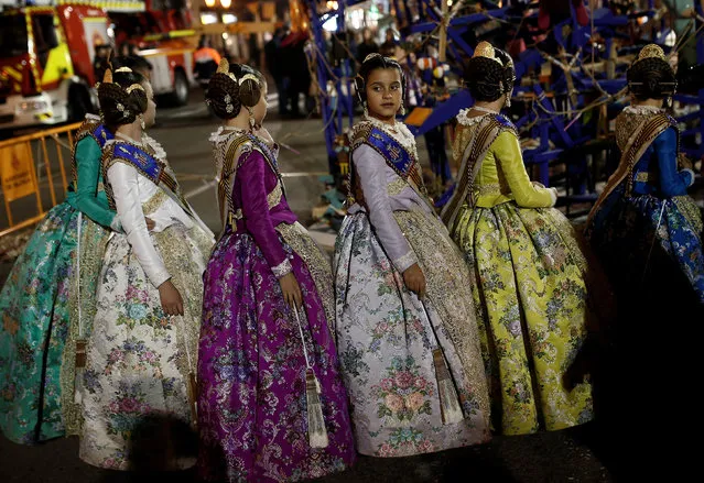 Participants wearing traditional costumes during the last day of Las Fallas festival in Valencia, Spain, on 19 March 2017. The Fallas festival takes place in Valencia from 15th to the 19th of March every year to commemorate the city's patron saint, St. Joseph. The festival ends with the burning of nearly 800 of large monuments known as 'ninots' which were placed around the city. (Photo by Burak Akbulut/Anadolu Agency/Getty Images)