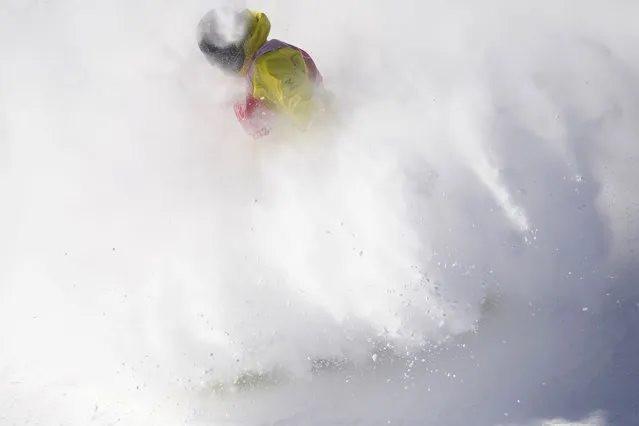 A snowboarder lands on the slopestyle course ahead of the 2022 Winter Olympics, Wednesday, February 2, 2022, in Zhangjiakou, China. (Photo by Francisco Seco/AP Photo)