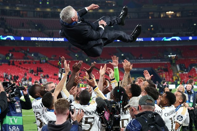 Players of Real Madrid throw their head coach Carlo Ancelotti in celebration after winning the UEFA Champions League final match of Borussia Dortmund against Real Madrid, in London, Britain, 01 June 2024. Real Madrid wins their 15th UEFA Champions League. (Photo by Adam Vaughan/EPA)