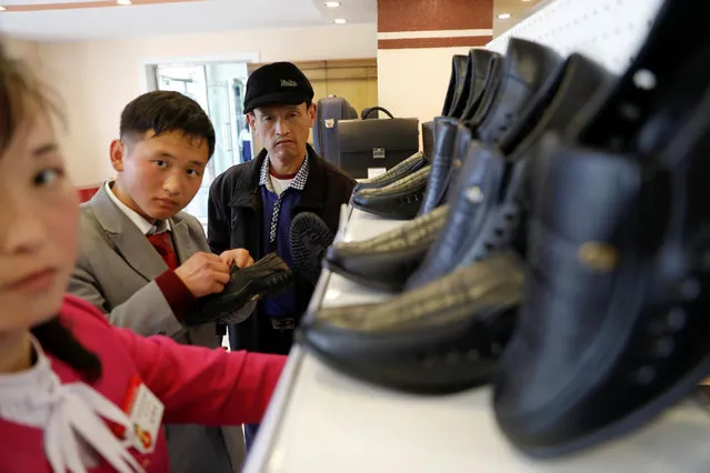 People check shoes in a shop in a newly constructed residential complex after its opening ceremony in Ryomyong street in Pyongyang, North Korea April 13, 2017. (Photo by Damir Sagolj/Reuters)