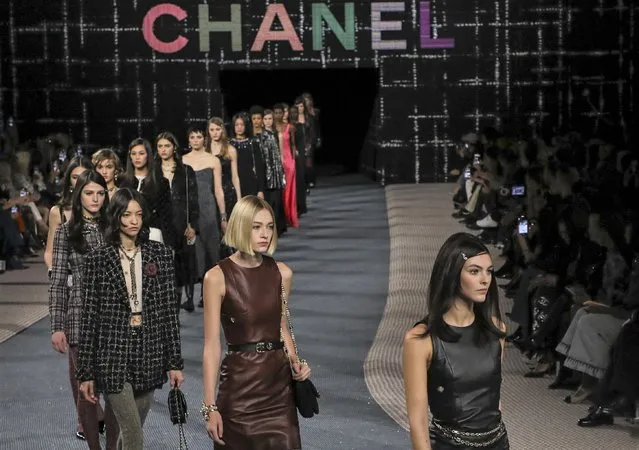 Models wear creations as part of the Chanel Ready To Wear Fall/Winter 2022-2023 fashion collection, unveiled during the Fashion Week in Paris, Tuesday, March 8, 2022. (Photo by Vianney Le Caer/Invision/AP Photo)