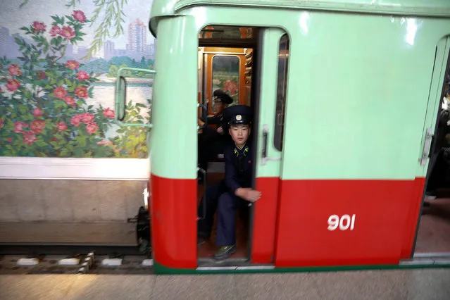 Railway worker closes the door as a train leaves a subway station visited by foreign reporters in central Pyongyang, North Korea on April 14, 2017. (Photo by Damir Sagolj/Reuters)