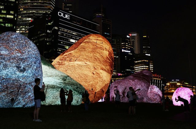 People interact with the Iwagumi Air Scape light art installation by Australian studio ENESS during the i Light Festival at the Marina Bay in Singapore, on June 13, 2024. (Photo by Edgar Su/Reuters)