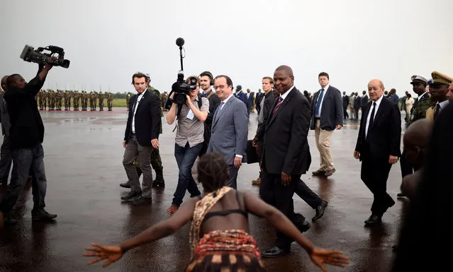 French President Francois Hollande (C) and French Defense minister Jean-Yves Le Drian (R) are welcomed by Central Africa's President Faustin Touadera (C) upon his arrival in Bangui, Central African Republic May 13, 2016. (Photo by Stephane De Sakutin/Reuters)