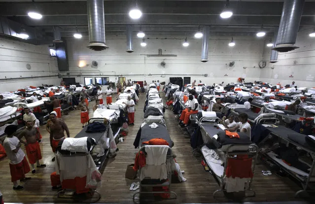Inmates walk around a gymnasium where they are housed due to overcrowding at the California Institution for Men state prison  in Chino, California, June 3, 2011. (Photo by Lucy Nicholson/Reuters)