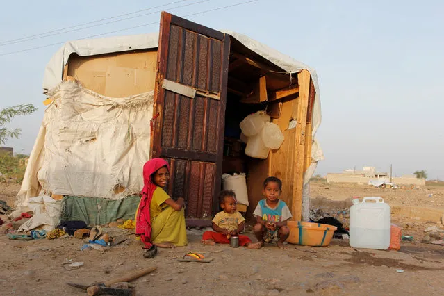 Children sit next to their hut at a makeshift camp for internally displaced people in al-Jarahi south of the Red Sea port city of Houdhieda, Yemen February 22, 2017. (Photo by Abduljabbar Zeyad/Reuters)