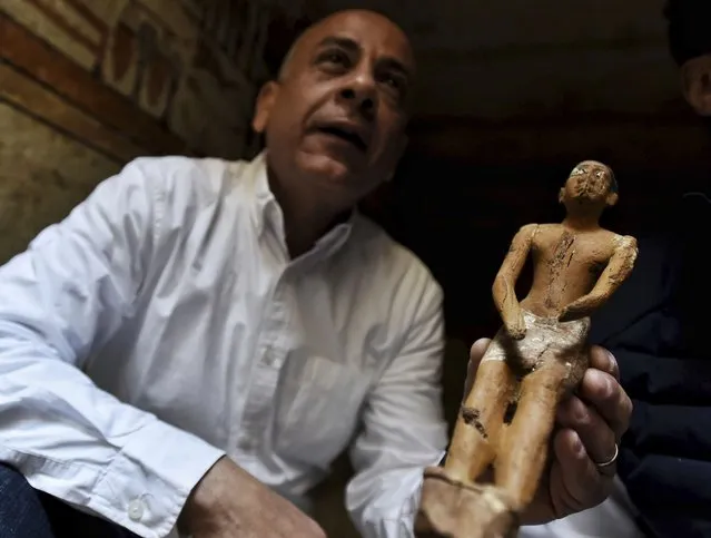 Mostafa Waziri, Secretary General of the Supreme Council of Antiquities, displays a statue found in a recently discovered tomb near the famed Step Pyramid, in Saqqara, south of Cairo, Egypt, Saturday, March 19, 2022. Egypt on Saturday displayed recently discovered tombs at an infamous Pharaonic necropolis just outside the capital of Cairo. The five tombs, unearthed earlier this month, date back to the Old Kingdom (1570 B.C. and 1069 B.C.) and the First Intermediate Period, an era spanned for around 125 years after the collapse of the old kingdom, according to the Ministry of Tourism and Antiquities. (Photo by Sayed Hassan/AP Photo)