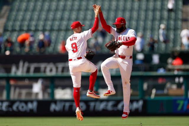 (L-R) Zach Neto #9 and Jo Adell #7 of the Los Angeles Angels celebrate after the final out in a team victory over the New York Mets at Angel Stadium of Anaheim on August 4, 2024 in Anaheim, California. The Angels defeated the Mets 3-2. (Photo by Brandon Sloter/Getty Images)