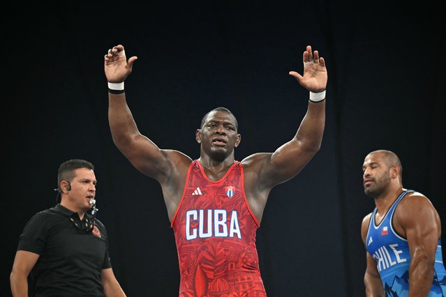 Cuba's Mijain Lopez Nunez reacts to his win over Chile's Yasmani Acosta Fernandez in their men's greco-roman 130kg wrestling final match at the Champ-de-Mars Arena during the Paris 2024 Olympic Games, in Paris on August 6, 2024. (Photo by Punit Paranjpe/AFP Photo)