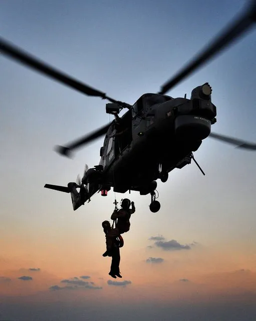 Winch Transfers training being carried out on the flight deck of HMS Montrose by L(Phot) Alex Knott taken from his portfolio which earned him the title of Royal Navy Photographer of the Year 2014. (Photo by Alex Knott/PA Wire)