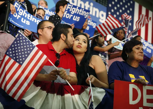 A couple kisses before a rally with Democratic presidential candidate Hillary Clinton, Saturday, June 4, 2016, in Fresno, Calif. (Photo by John Locher/AP Photo)