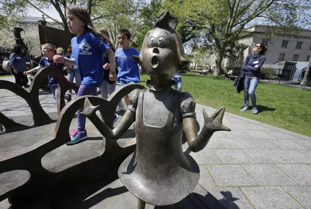 In this May 4, 2017, photo children play near a bronze statue of a Dr. Seuss character at the The Dr. Seuss National Memorial Sculpture Garden, in Springfield, Mass. The Amazing World of Dr. Seuss Museum, which devoted to Dr. Seuss, opened on June 3 in his hometown. (Photo by Steven Senne/AP Photo)